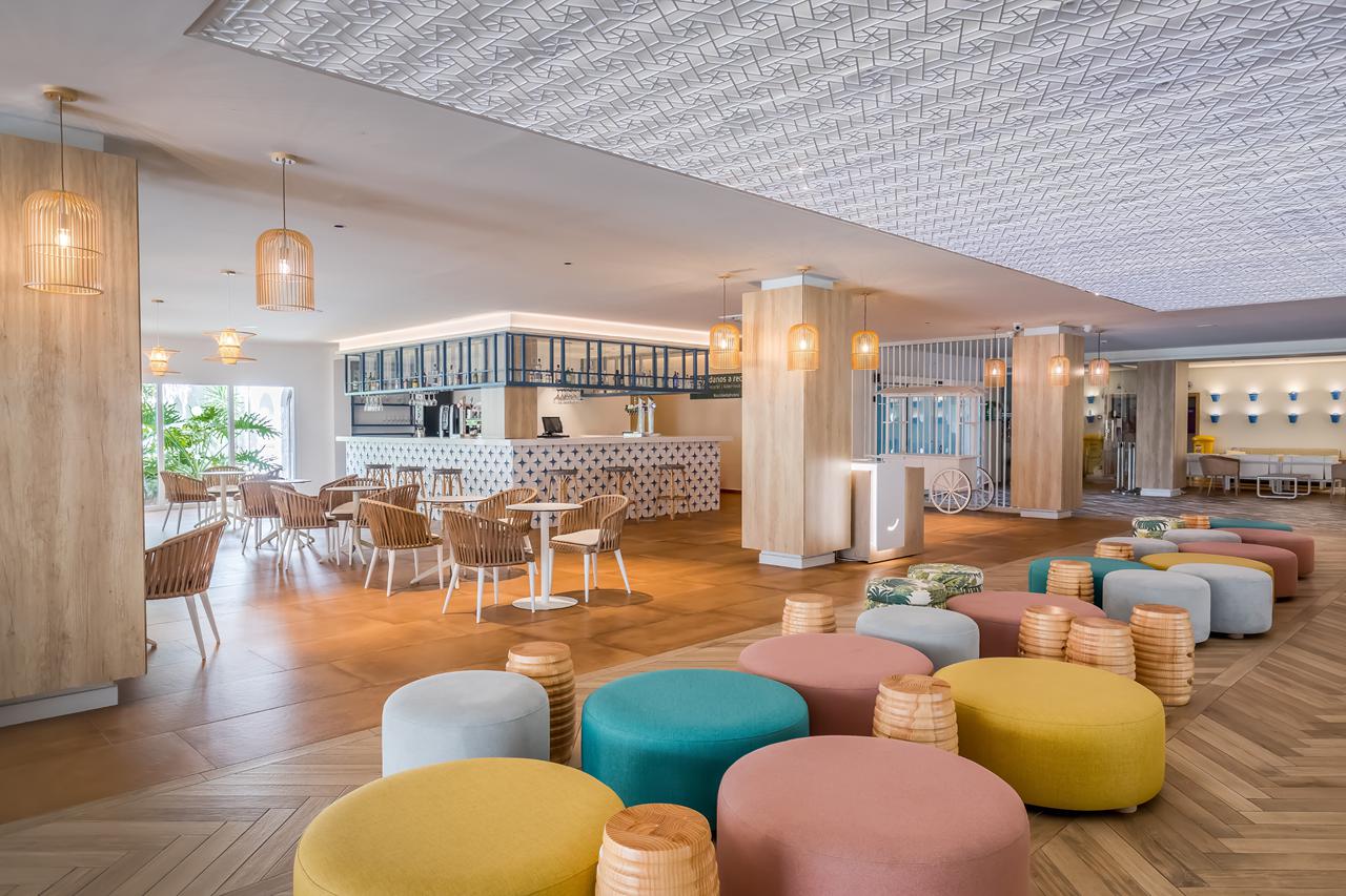Lounge van Occidental Torremolinos Playa met zitbanken en kleurrijke poefs